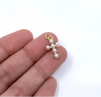Cross charm on hand for size reference 