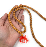 8mm Sandalwood Mala Bead shown on hand for size reference 