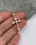 Cross pendant on hand for size reference