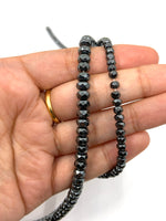 Faceted hematite beads on hand for size reference
