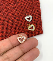 Heart charm on hand for size reference