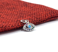 Silver evil eye charm with multi colored stones