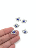 Evil eye charms on hand for size reference